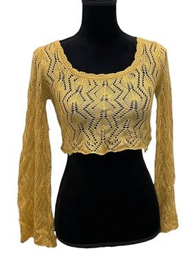 mustard yellow crochet long-sleeve crop top with a flared bell sleeve design